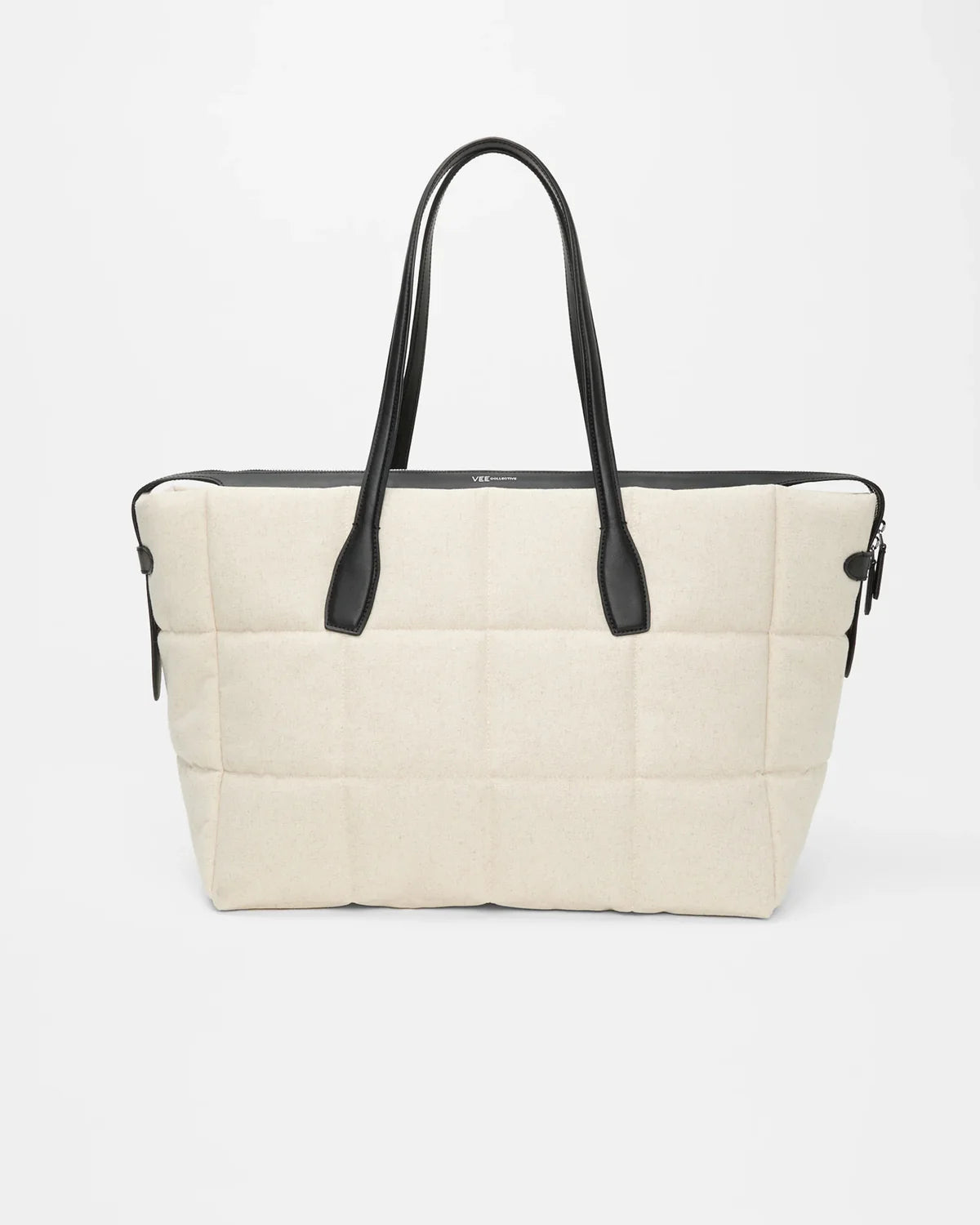 Beige tote bag with black handles on a white background