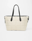 Beige tote bag with black handles on a white background