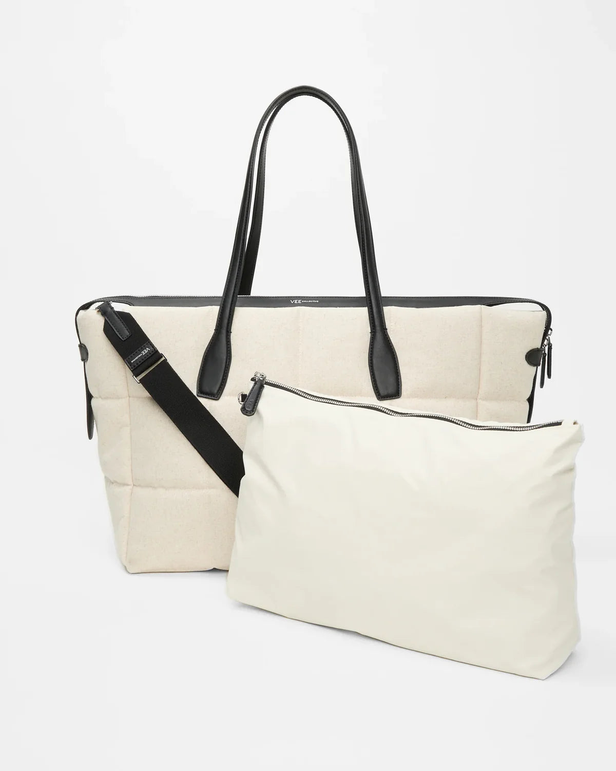 White handbag with black straps on a white background