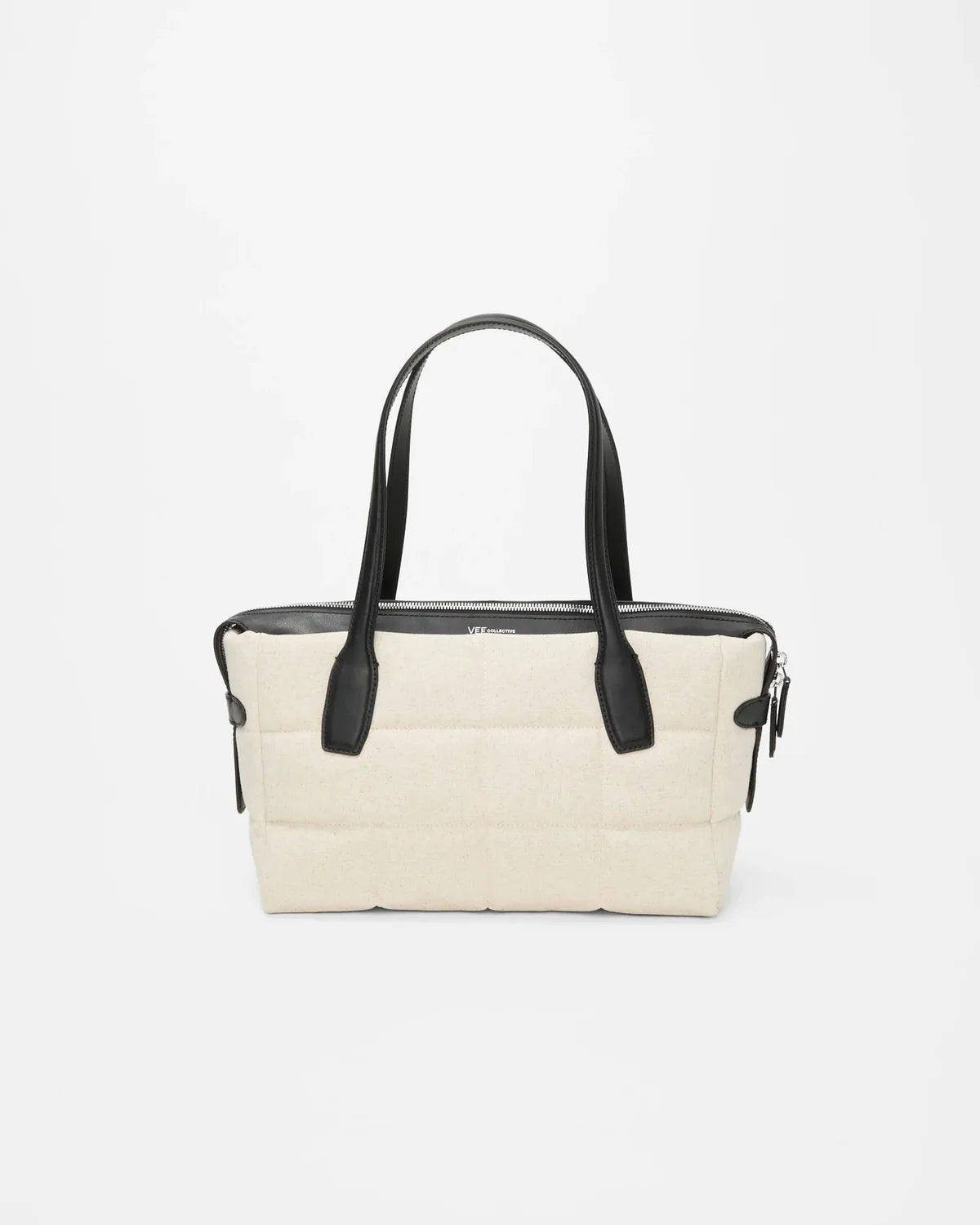 Beige handbag with black handles on a white background
