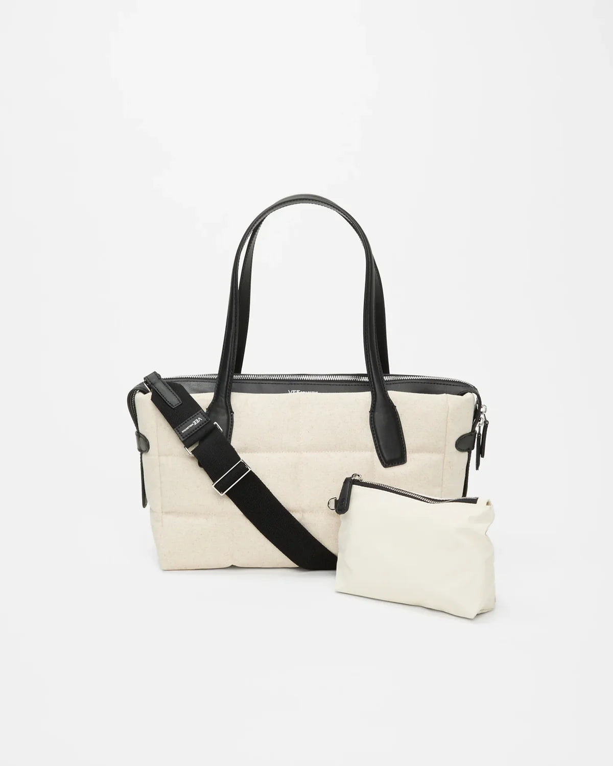 White handbag with black straps on a light gray background