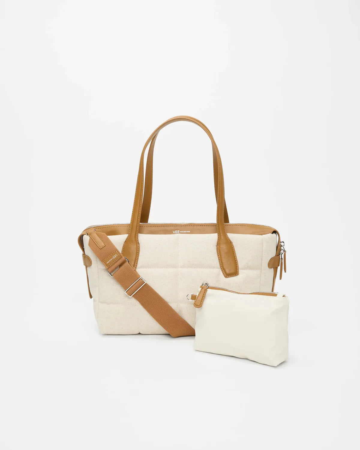 Beige handbag with brown strap on a white background