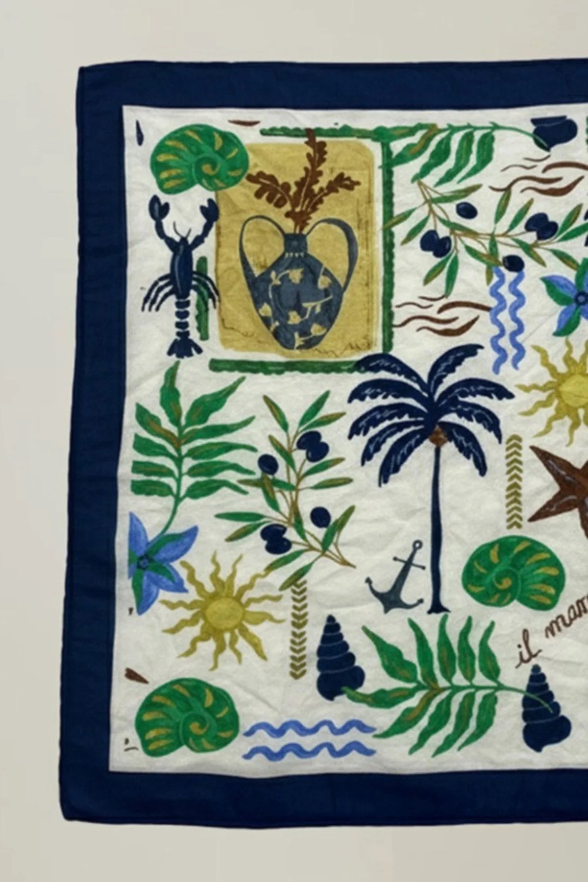 Decorative handkerchief with tropical patterns and symbols on a white background