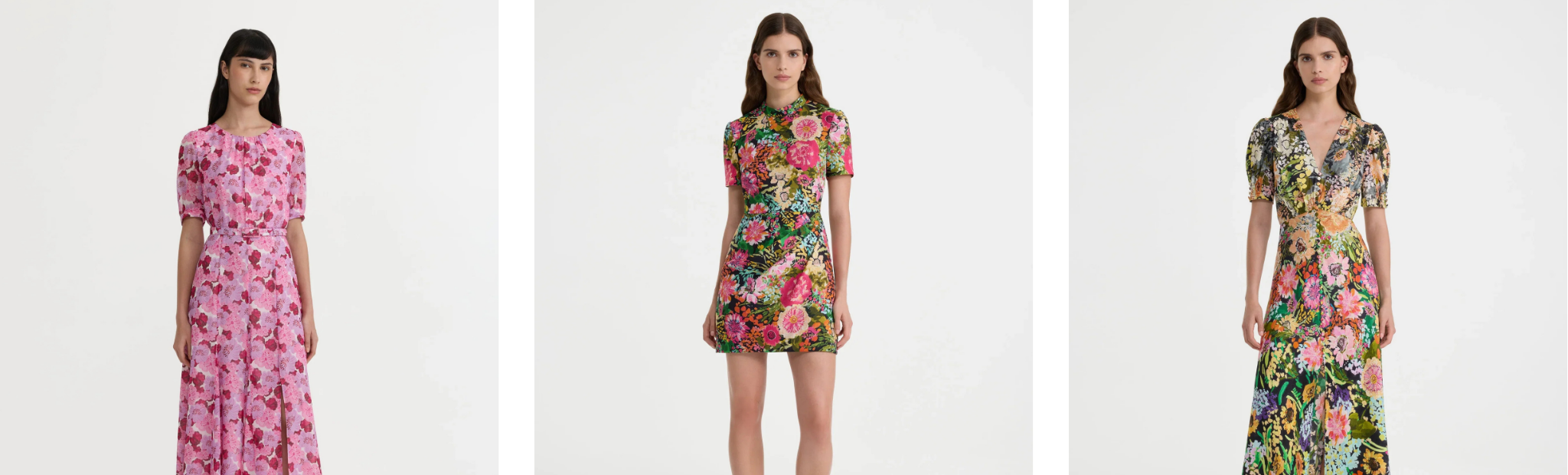 Three models wearing short-sleeve floral midi dresses shown side by side against a plain white background. The dresses feature different floral patterns: pink with red flowers, multicolor with green and red flowers, and multicolor with yellow and pink flowers.