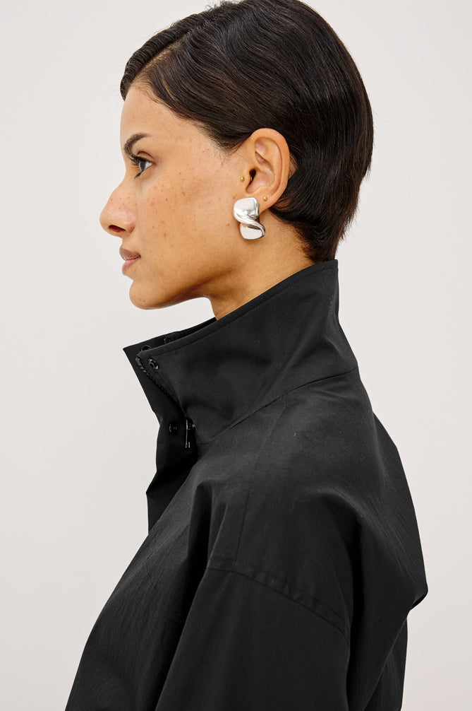 Woman wearing a black jacket with a white background