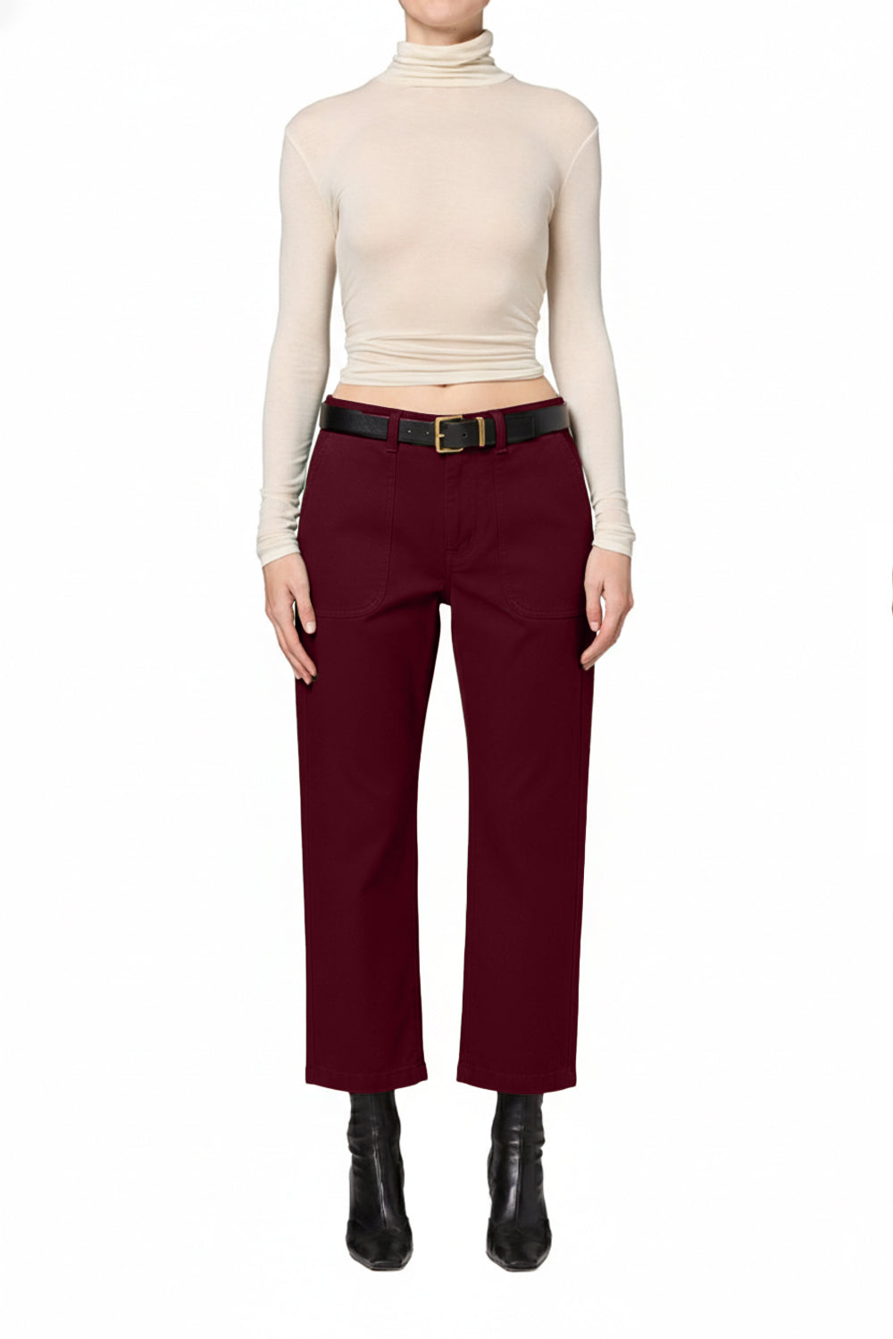 A model wearing a cream ribbed mock neck crop top, deep burgundy wide-leg trousers with a black belt, and black ankle boots, shown against a plain white background.