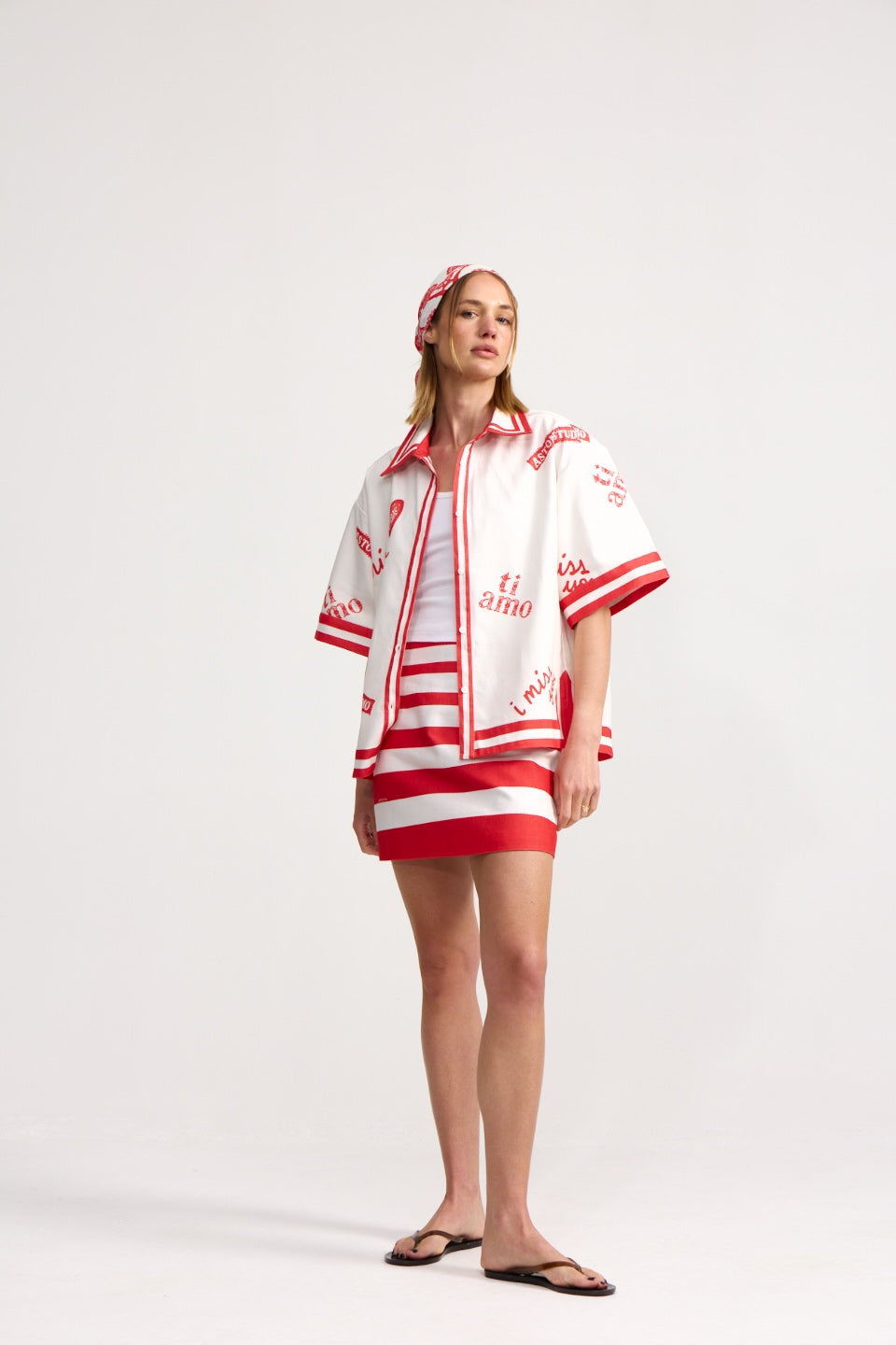 Woman wearing a red and white outfit with a matching headband on a white background