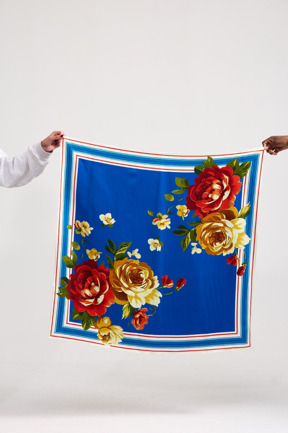 a blue scarf with florals with a white background