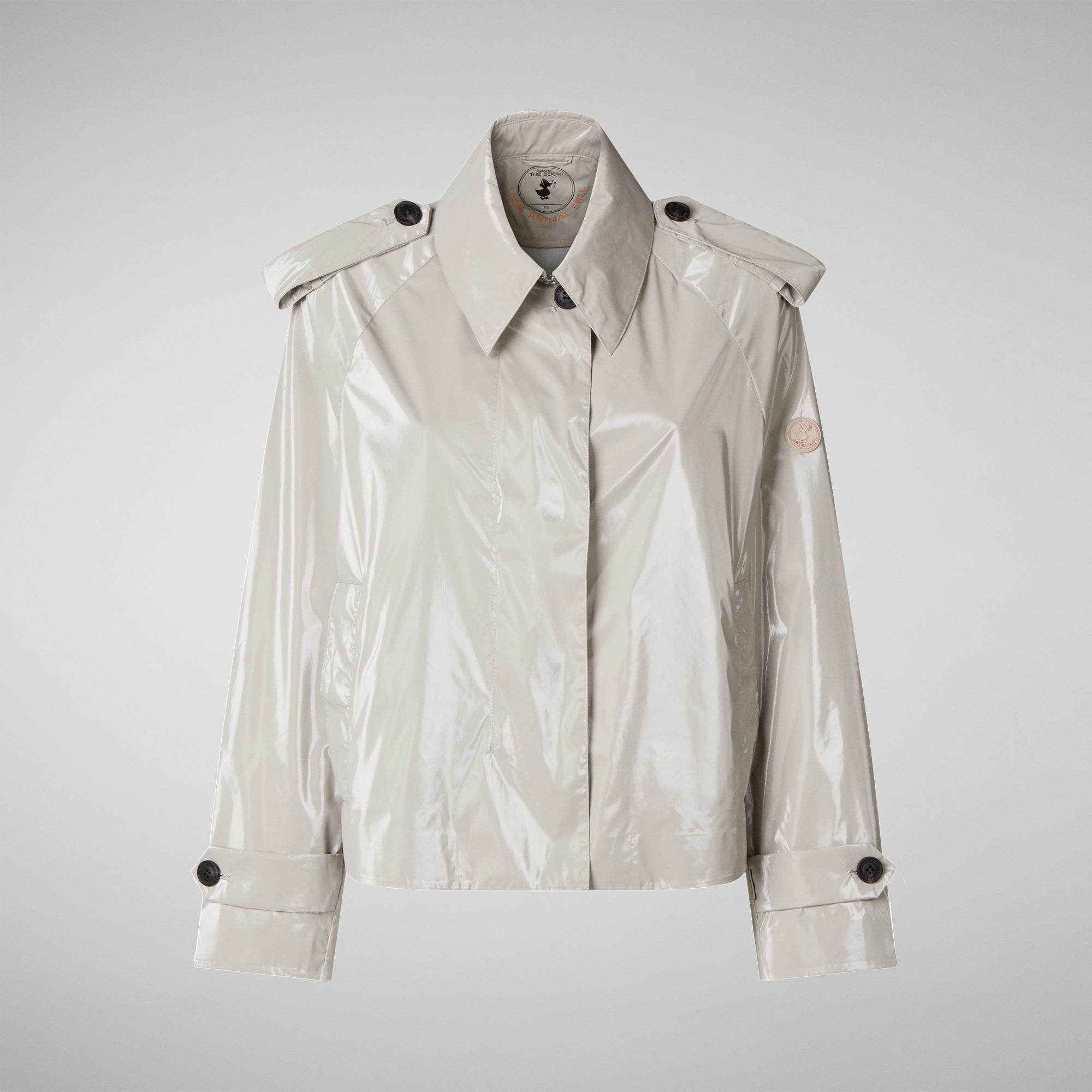 White raincoat with black buttons on a light gray background
