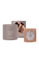 A roll of nude beige shape tape with a matching cylindrical container, both branded 'NOODIST' and 'NEW YORK', on a clean white background.