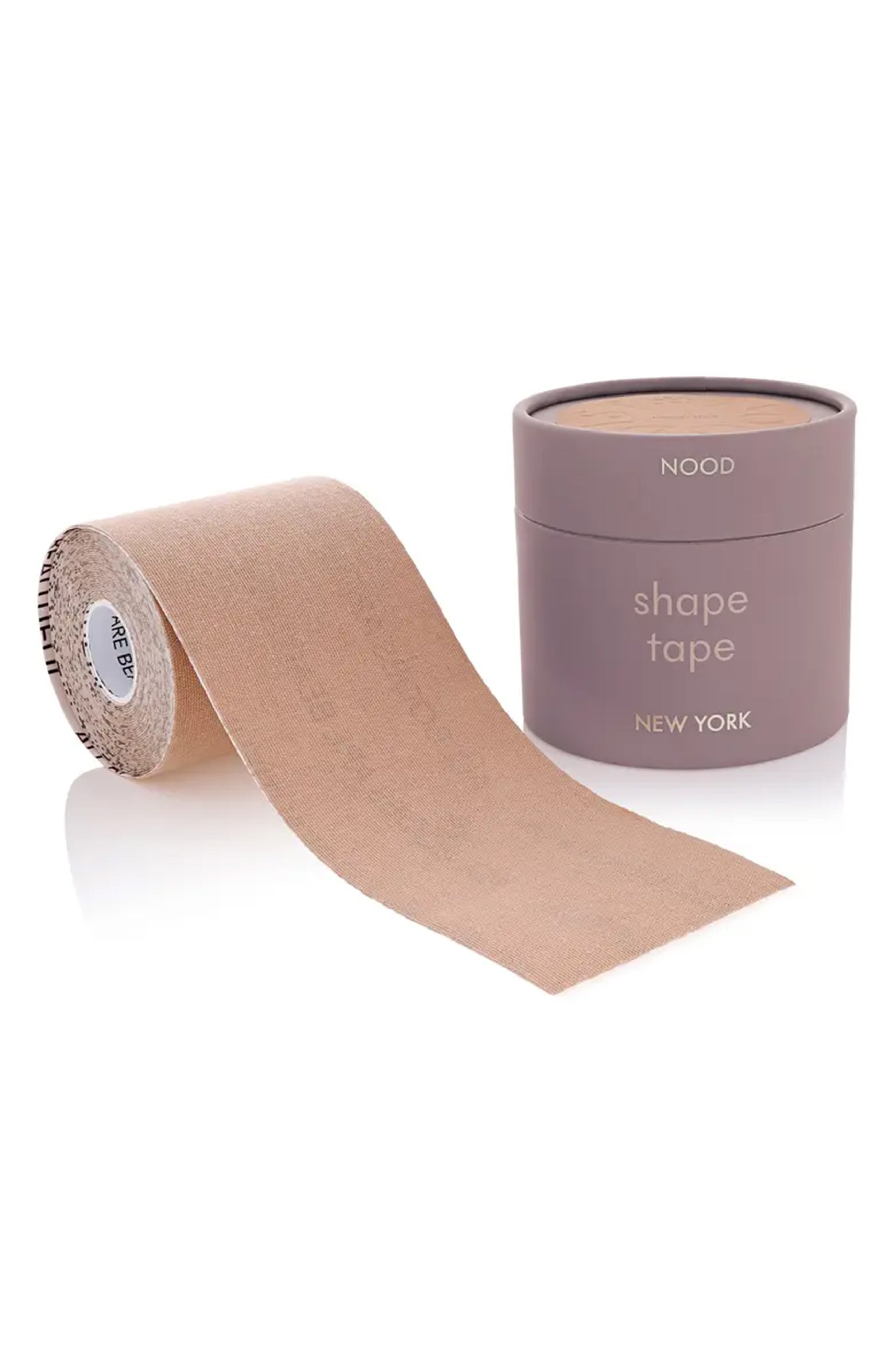 A roll of nude beige shape tape with a matching cylindrical container, both branded 'NOCO' and 'NEW YORK', on a clean white background.