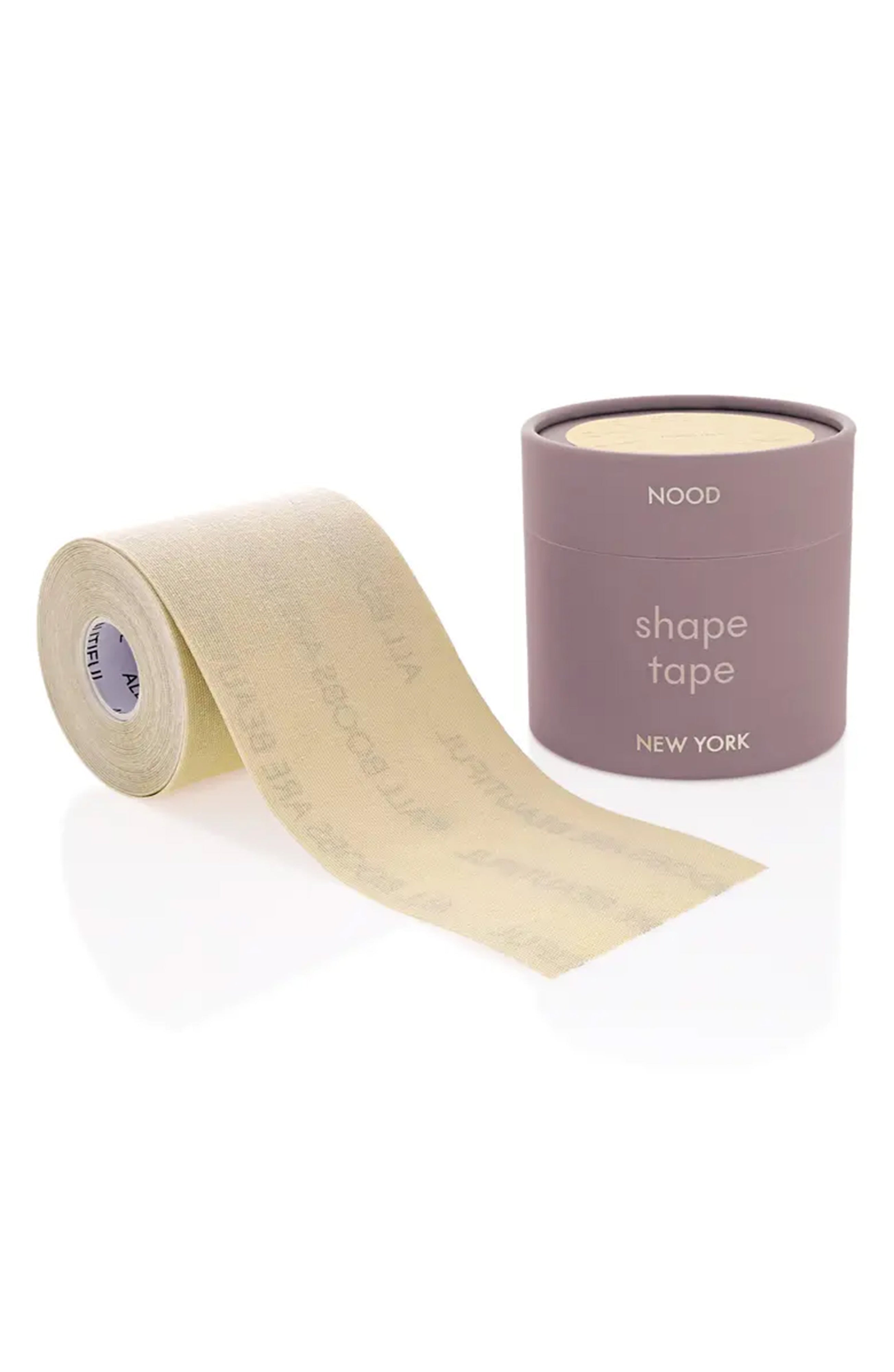 A roll of beige shape tape with its matching mauve-colored cylindrical packaging container on a clean white background. The packaging features the brand name 'NOOD' and the text 'shape tape NEW YORK'.