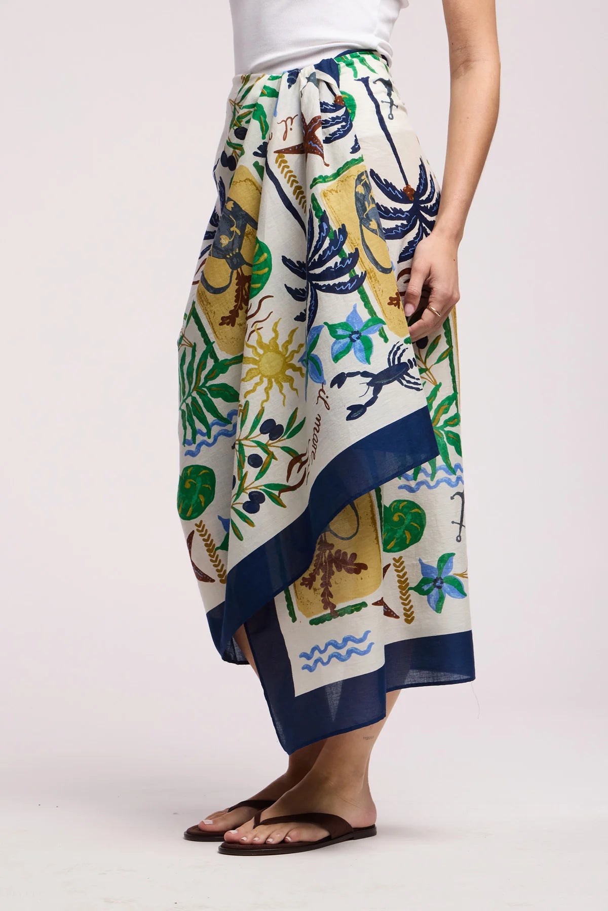 Person wearing a colorful patterned skirt on a white background