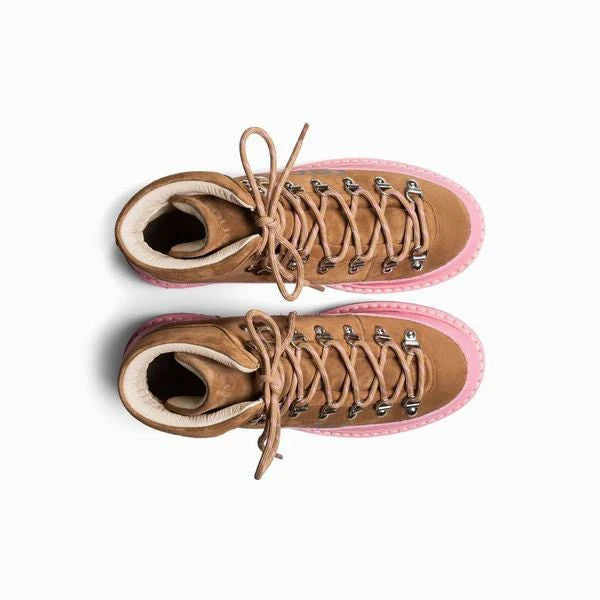 Pair of brown boots with pink soles on a white background